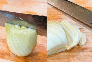 fennel on a cutting board being cut in half and sliced with a chef's knife