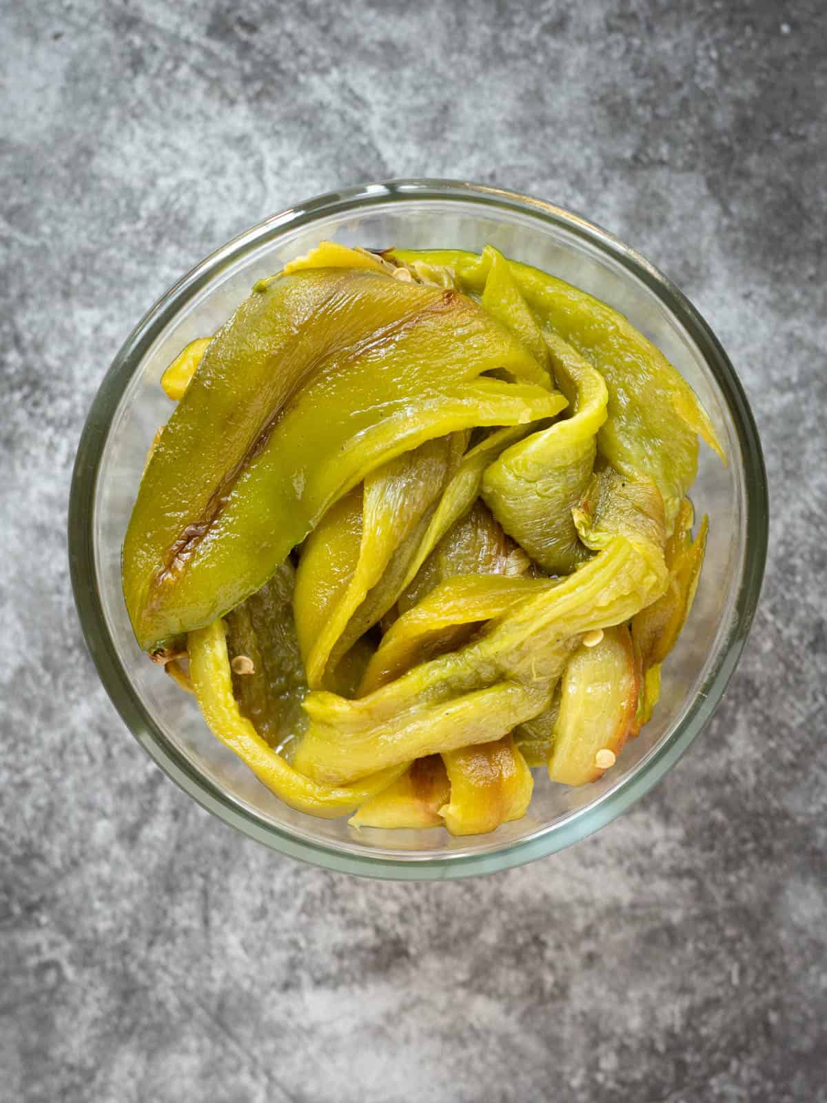 Photo of roasted green chiles in a glass jar