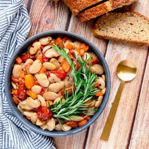 Italian butter beans in a bowl with a spoon and bread