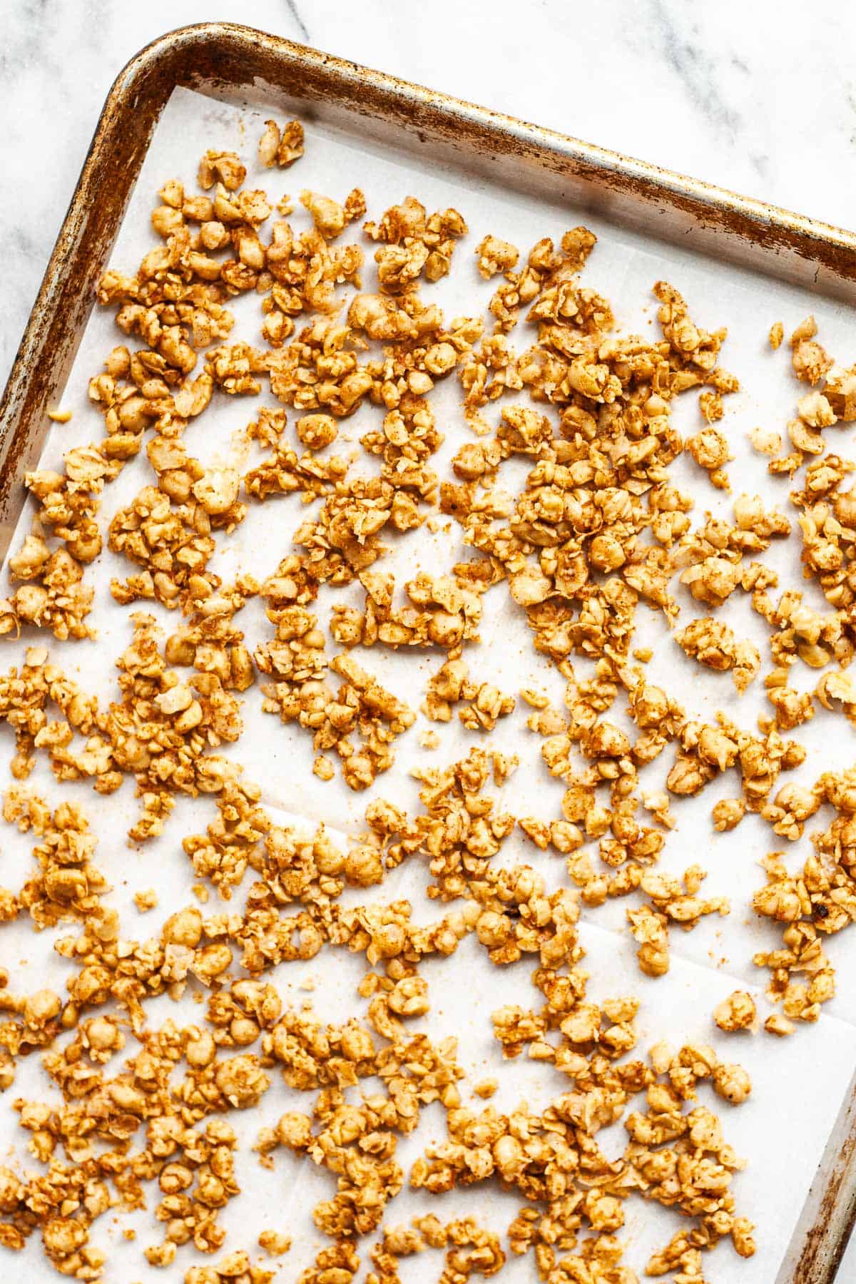 Roasted chickpeas on a parchment-lined baking sheet.