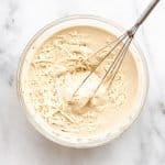 tahini Caesar dressing in a bowl with a whisk