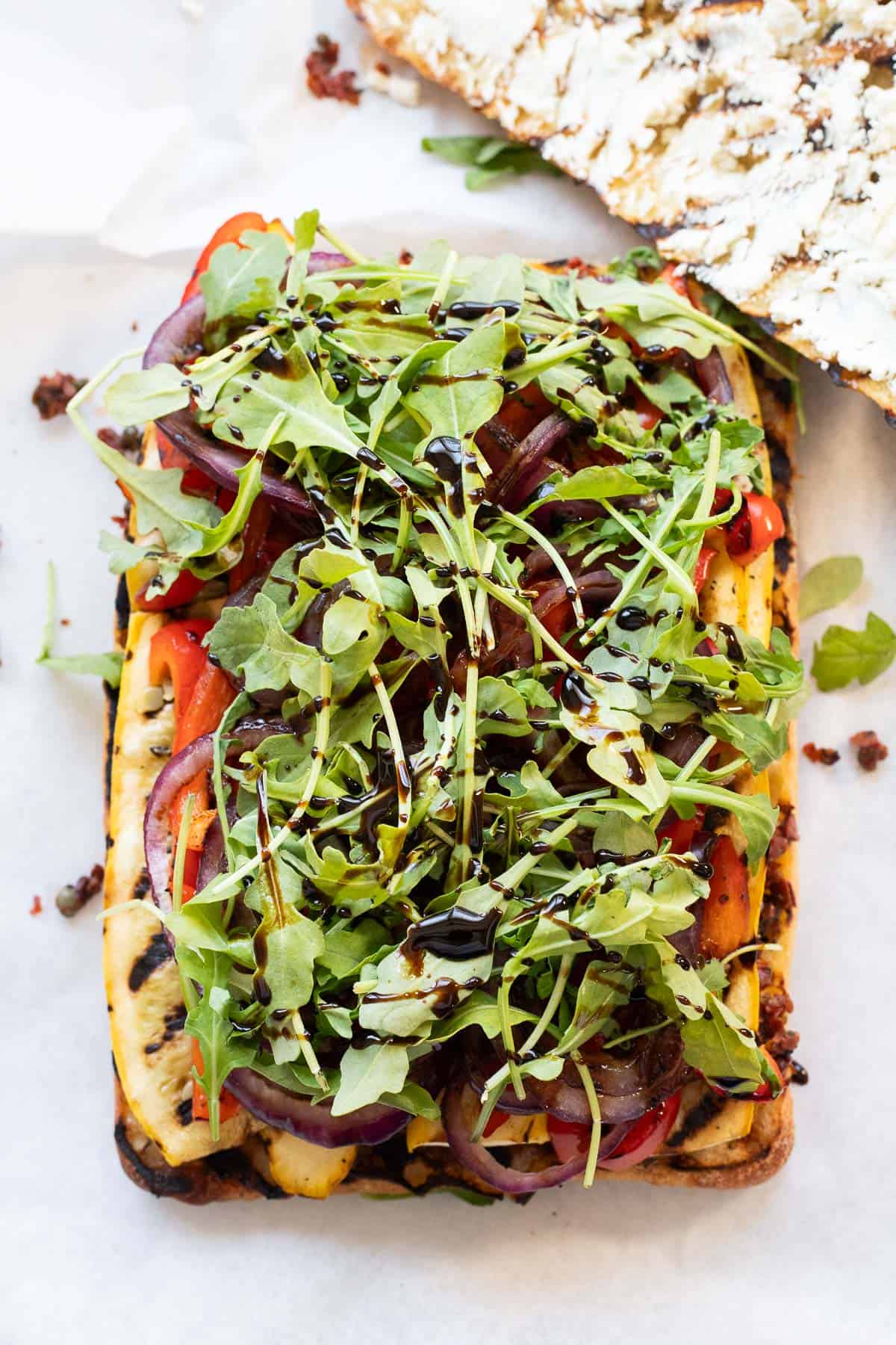 Grilled ciabatta layered with sundried tomato and olive tapenade, grilled vegetables, arugula, and balsamic drizzle.