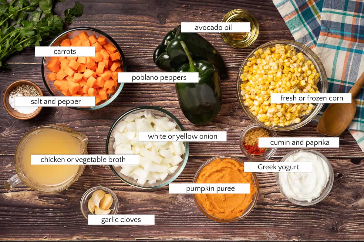 Ingredients for pumpkin poblano corn chowder: carrots, salt and pepper, poblano peppers, avocado oil, fresh or frozen corn, cumin and paprika, Greek yogurt, pumpkin puree, garlic cloves, white or yellow onion, and chicken or vegetable broth.