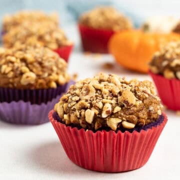whole grain pumpkin hazelnut muffins on a white background