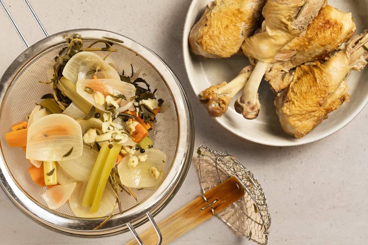 Turkey and vegetables are removed from the broth after it has been simmering for an hour