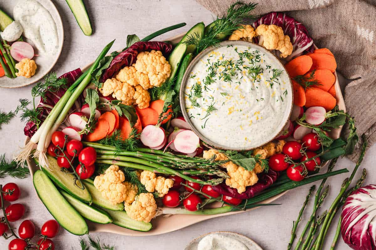 memorial day appetizers dill veggie dip on a platter with vegetables.