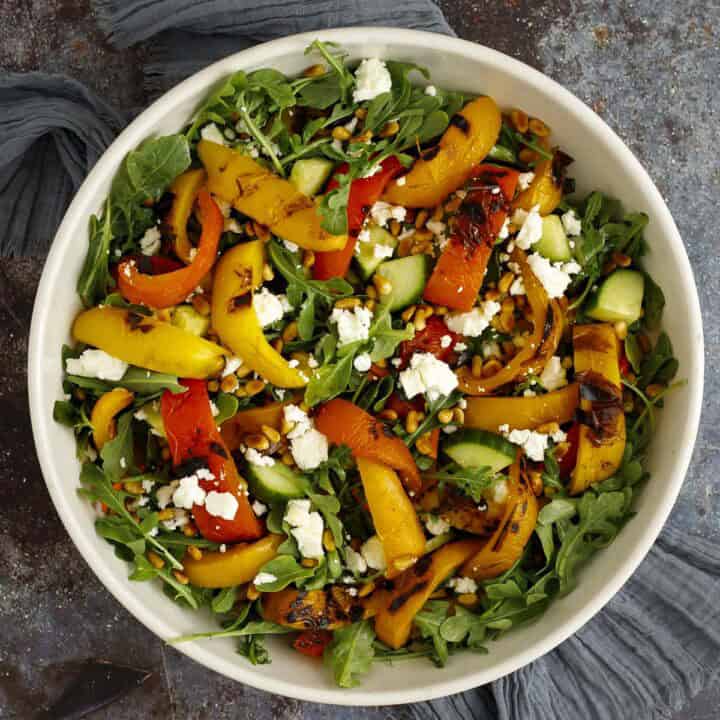 grilled pepper salad with arugula and feta in a bowl