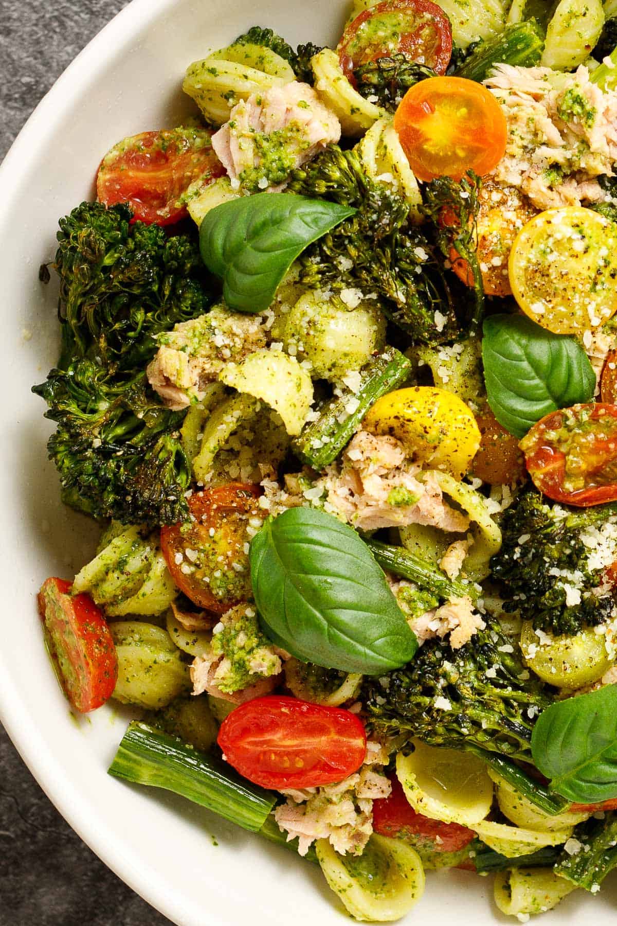 Close-up of broccolini pasta with tuna and pesto in a bowl.