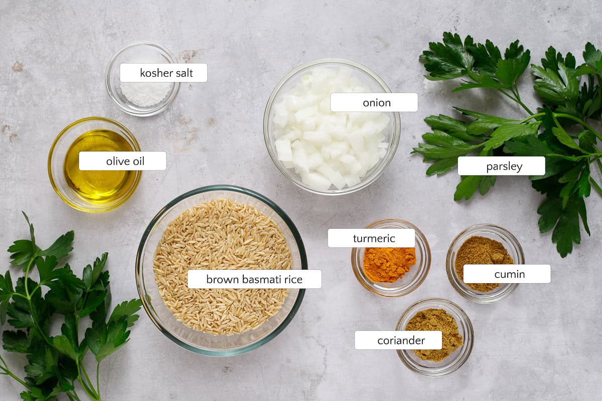 Ingredients for Mediterranean yellow rice include olive oil, salt, cumin, coriander, turmeric, parsley, and basmati brown rice