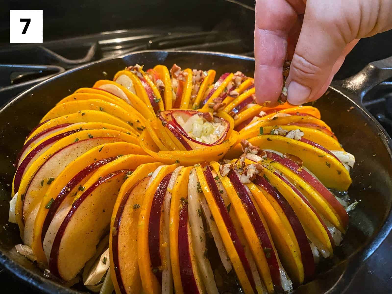 Step 7: Mix together chopped pecans, orange zest, and rosemary. Uncover the tian and sprinkle the nut mixture over the top. Return to the oven for 5-10 minutes.