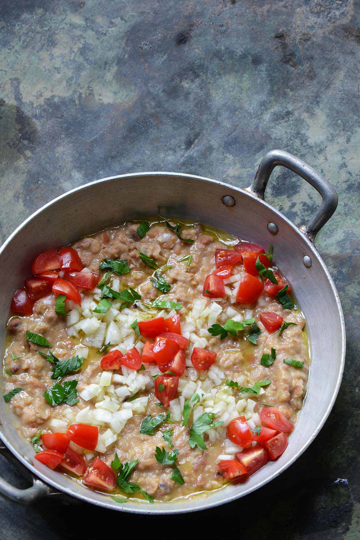 Foul Mudammas Mediterranean diet breakfast in a steel pan.