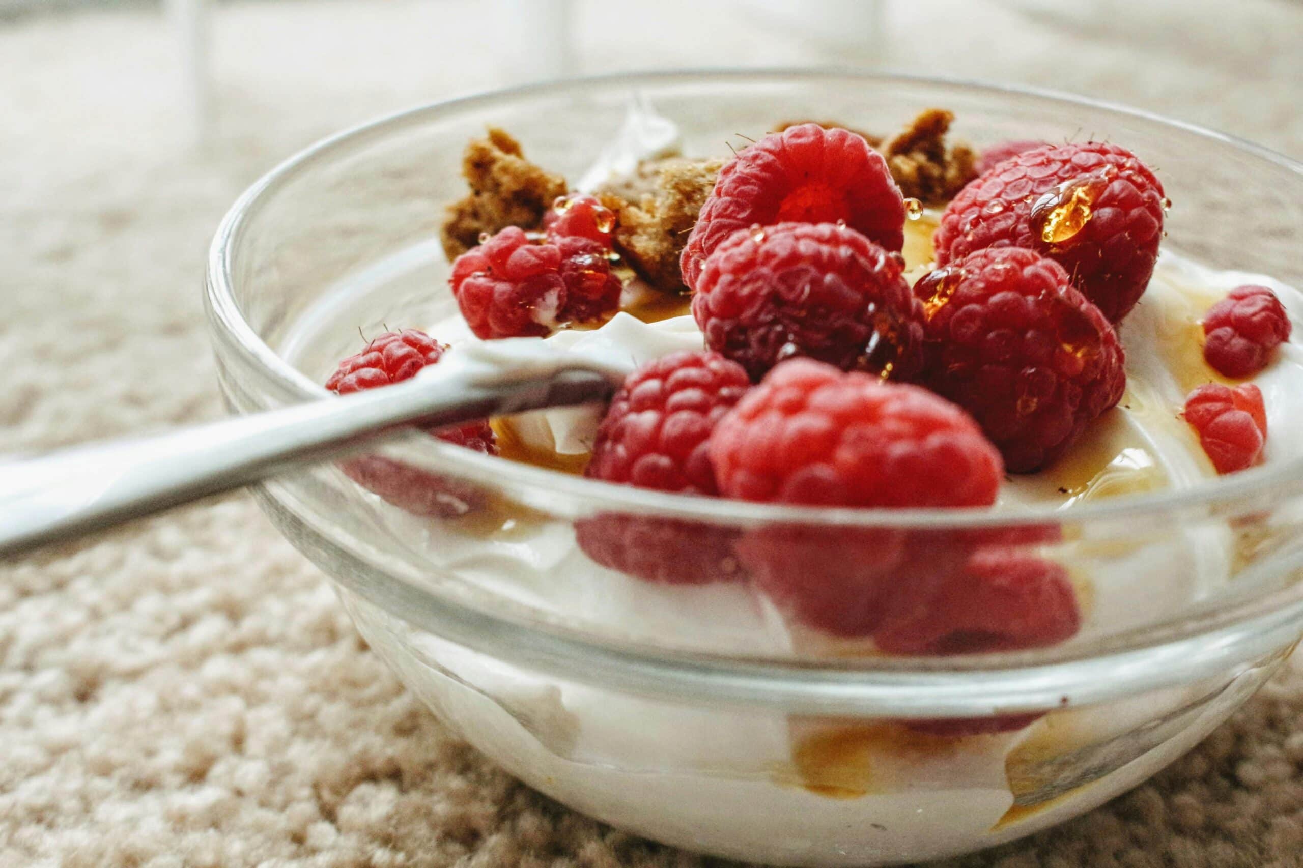 A bowl of yogurt and berries drizzled with olive oil.