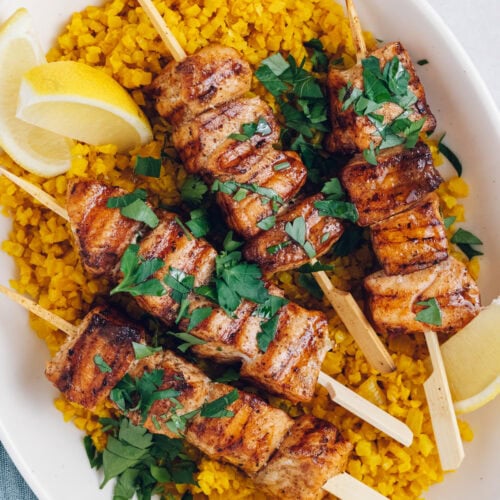 cubes of salmon threaded on to skewers and grilled, served with yellow cauliflower rice.
