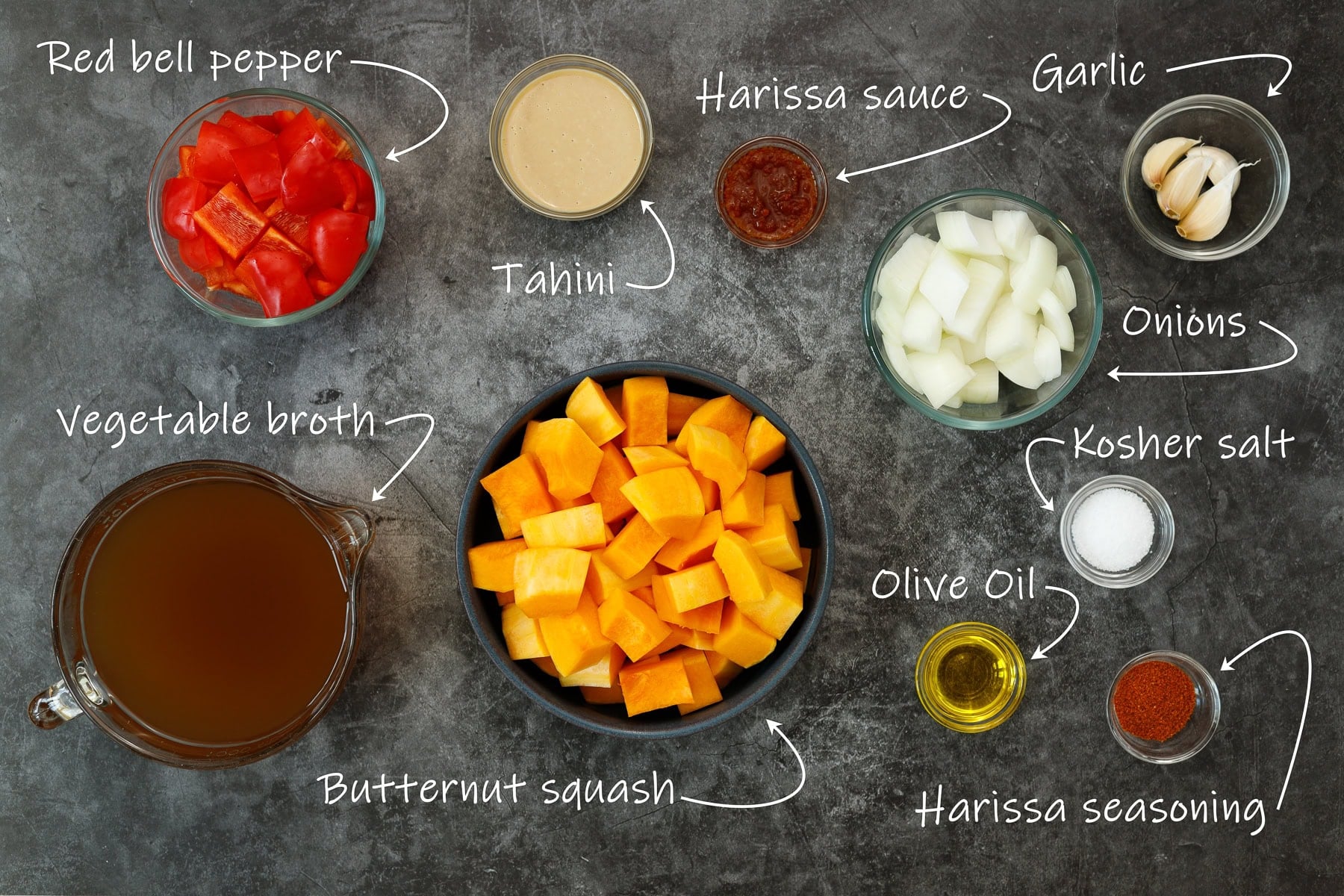 Ingredients for butternut squash and red pepper soup: butternut squash, onion, red bell pepper, garlic, salt, olive oil, harissa paste, harissa seasoning, tahini, and low-sodium broth.